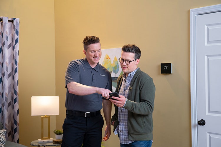comfortmaker-dealer-showing-man-smart-thermostats